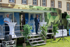 Deputy Mayor Resch standing on the stage and conveying the greetings from the municipality of Bischofswiesen through the microphone