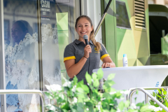 Sergeant Langenhorst standing on the stage, holding the microphone in her hand and beaming with joy